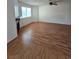 A view of an empty living room featuring laminate flooring, a ceiling fan, and a fireplace at 2232 Aspen Mirror Way # 204, Laughlin, NV 89029