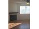 Bright living area featuring a fireplace, large window and hardwood flooring at 2232 Aspen Mirror Way # 204, Laughlin, NV 89029