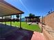 Backyard featuring artificial grass, a covered patio, pergola and privacy fencing at 3105 Palo Verde Dr, Laughlin, NV 89029