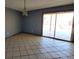A spacious room with tile flooring leading to a sliding glass door at 3105 Palo Verde Dr, Laughlin, NV 89029