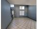 Spacious living room with staircase, neutral-toned walls, tile floor, and natural light at 3105 Palo Verde Dr, Laughlin, NV 89029