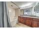 Bright bathroom featuring a double vanity and a combined bathtub and shower with neutral earth tones at 3411 Sunfish Dr # B, Henderson, NV 89014