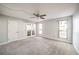 Bedroom area with a ceiling fan, wall-to-wall carpet, and door to enclosed patio at 3411 Sunfish Dr # B, Henderson, NV 89014