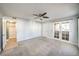 Bedroom area with carpeted floors, ceiling fan, closet, and access to the enclosed patio at 3411 Sunfish Dr # B, Henderson, NV 89014