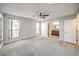 Bedroom area with a ceiling fan, wall-to-wall carpet, and open access to a bathroom at 3411 Sunfish Dr # B, Henderson, NV 89014