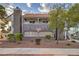 Two-story condo with a red tile roof and a desert landscape near the building at 3411 Sunfish Dr # B, Henderson, NV 89014