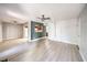 Open living area with wood-look floors, ceiling fan, view to kitchen, and plenty of natural light at 3411 Sunfish Dr # B, Henderson, NV 89014