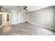 Spacious living room showcasing wood-look floors, a ceiling fan, neutral paint, and a hallway view at 3411 Sunfish Dr # B, Henderson, NV 89014