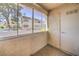 Enclosed patio featuring textured walls and views of an apartment building and parking area at 3411 Sunfish Dr # B, Henderson, NV 89014