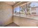 Enclosed patio featuring textured walls and view of a parking area and nearby apartment buildings at 3411 Sunfish Dr # B, Henderson, NV 89014
