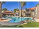 Inviting community pool area with lounge chairs, shaded seating, and well-maintained landscaping on a sunny day at 3411 Sunfish Dr # B, Henderson, NV 89014