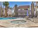 Relaxing pool area with a hot tub, lounge seating, and swaying palm trees at 3411 Sunfish Dr # B, Henderson, NV 89014