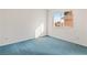 Bright bedroom features a window and blue carpet at 3426 Dry Gulch Dr, Laughlin, NV 89029