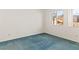 Bright bedroom featuring large windows, carpet flooring, and neutral walls at 3426 Dry Gulch Dr, Laughlin, NV 89029
