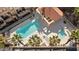 Aerial view of community pool featuring a spa, covered seating, and tiled roofs at 3426 Dry Gulch Dr, Laughlin, NV 89029