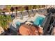 High angle view of a community pool showcasing the spa, lounge area, lush landscaping and surrounding tile roofs at 3426 Dry Gulch Dr, Laughlin, NV 89029