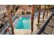 Aerial view of the community pool with cabana, spa, lounge chairs, tables, and lush landscaping at 3426 Dry Gulch Dr, Laughlin, NV 89029