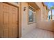 Welcoming front entry featuring a tiled patio and a well-lit, covered doorway at 3426 Dry Gulch Dr, Laughlin, NV 89029