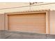 Tan garage door with rectangular pattern at 3426 Dry Gulch Dr, Laughlin, NV 89029