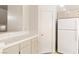 Bright kitchen featuring tiled countertops, stainless steel sink, white cabinets and refrigerator at 3426 Dry Gulch Dr, Laughlin, NV 89029