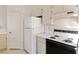 Close up of kitchen appliances, featuring a white refrigerator and matching range at 3426 Dry Gulch Dr, Laughlin, NV 89029