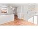Bright living room with wood floors, large window, and a partial view of the kitchen at 3426 Dry Gulch Dr, Laughlin, NV 89029