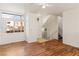 Open-concept living room with hardwood floors and stairs, featuring natural light at 3426 Dry Gulch Dr, Laughlin, NV 89029