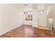 This is a large open living room with wood floors and two windows, located near the entrance at 3426 Dry Gulch Dr, Laughlin, NV 89029