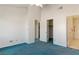 Spacious main bedroom with carpet, ceiling fan, and access to closet and bathroom at 3426 Dry Gulch Dr, Laughlin, NV 89029