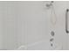 Shower-tub combination with white tile surround and shower head at 3426 Dry Gulch Dr, Laughlin, NV 89029