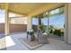 Inviting covered patio with seating, offering a relaxing outdoor space with views of the landscaped backyard at 350 Gandara St, Las Vegas, NV 89138