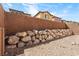 View of the backyard featuring retaining walls, and desert landscaping at 3637 Pinnate Dr, Las Vegas, NV 89147