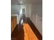 Upstairs hallway boasting wood floors, white railing and natural light at 3637 Pinnate Dr, Las Vegas, NV 89147