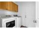 Bright laundry room with front load washer and dryer, plus storage cabinets at 3637 Pinnate Dr, Las Vegas, NV 89147
