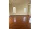 Bright living room featuring hardwood floors and natural light from the two windows at 3637 Pinnate Dr, Las Vegas, NV 89147