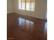 Bright living room featuring hardwood floors, a security door, and natural light from the windows at 3637 Pinnate Dr, Las Vegas, NV 89147