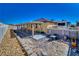 Home's backyard features covered patio and desert landscaping in a private setting at 3854 E Chaffe Ave, Pahrump, NV 89061