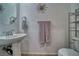 Bathroom featuring a pedestal sink, decorative wall art and shelving at 3854 E Chaffe Ave, Pahrump, NV 89061