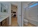 Bright bathroom with a shower/tub combo, toilet, and view into an adjacent bedroom at 3854 E Chaffe Ave, Pahrump, NV 89061