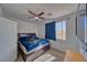 Comfortable bedroom featuring a ceiling fan, window with curtains, and a cozy bed with storage drawers at 3854 E Chaffe Ave, Pahrump, NV 89061
