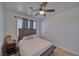 Bright bedroom with ceiling fan and bedside table featuring a window for natural light at 3854 E Chaffe Ave, Pahrump, NV 89061