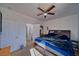 Cozy bedroom with carpet flooring, ceiling fan, and a bed with storage drawers, adjacent to the bathroom at 3854 E Chaffe Ave, Pahrump, NV 89061