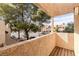 Private balcony overlooking mature trees and lush landscaping at 3949 S Torrey Pines Dr, Las Vegas, NV 89103