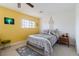 Bright bedroom with plush carpet, a double bed, and a yellow accent wall at 3949 S Torrey Pines Dr, Las Vegas, NV 89103