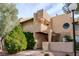 Inviting condo featuring a unique facade, covered entry, and mature landscaping at 3949 S Torrey Pines Dr, Las Vegas, NV 89103
