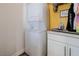 A convenient laundry area features a stacked washer and dryer unit and a cabinet for storage at 3949 S Torrey Pines Dr, Las Vegas, NV 89103