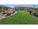 Spacious backyard with a lush lawn, comfortable seating, and a patio at 4680 Suntree Ct, Pahrump, NV 89061