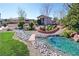 Backyard featuring charming water feature, rock landscaping, and a quaint garden shed at 4680 Suntree Ct, Pahrump, NV 89061