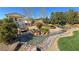 Backyard view showcasing water feature, bridge, lush landscaping, and a garden shed at 4680 Suntree Ct, Pahrump, NV 89061