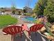 A backyard oasis with stream, pond, flowers and comfortable lounge chairs at 4680 Suntree Ct, Pahrump, NV 89061